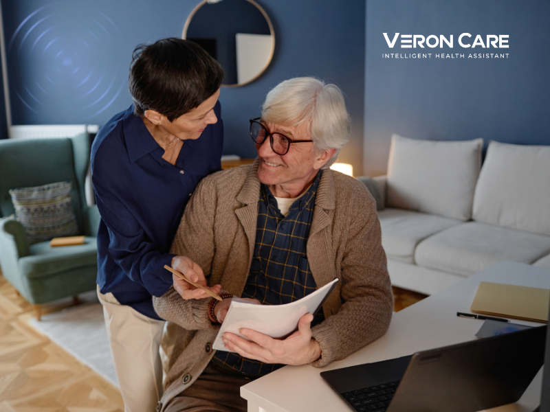 Senior couple reviewing daily activity insights at home with Veron Care intelligent health monitoring.